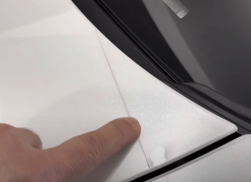 Gaps in paint protection film (PPF) on a car's hood.
