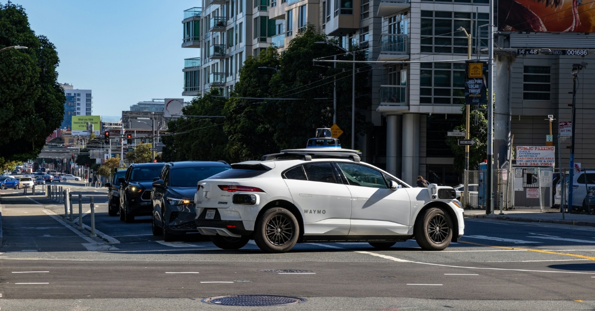 A Waymo autonomous vehicle operates on the street.